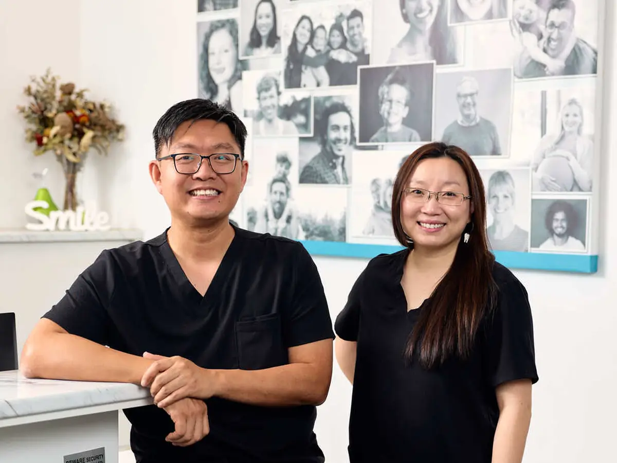 Our dentists at the reception desk at Care Dental Camberwell